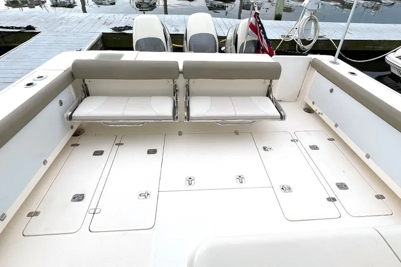 Slide: The Image of 2009 Pursuit OS 375 Offshore boat deck with foldable seats and storage compartments. - 5