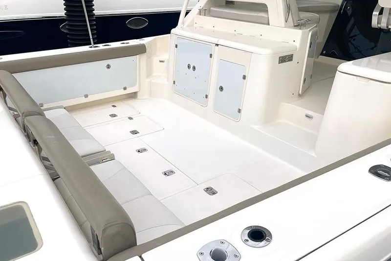 Slide: The Image of 2009 Pursuit OS 375 Offshore boat deck with seating and storage compartments. - 6