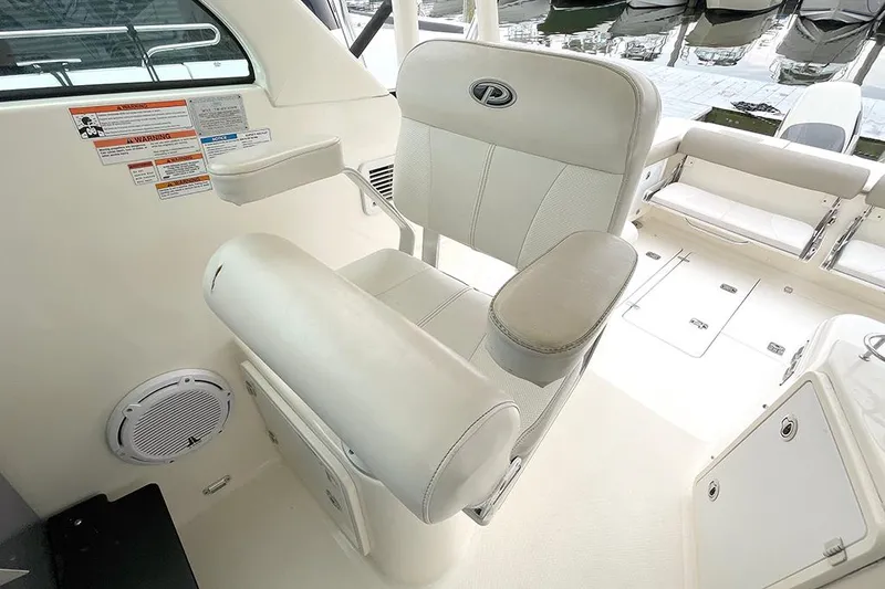 Slide: The Image of Captain's chair on 2009 Pursuit OS 375 Offshore boat, white leather upholstery. - 9