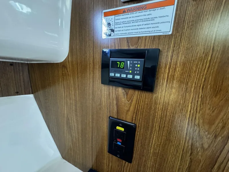 Slide: The Image of Control panel and warning label inside a 2010 Pursuit OS 345 Offshore boat. - 19
