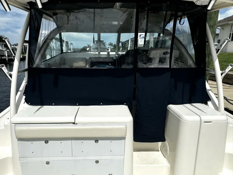 Slide: The Image of 2010 Pursuit OS 345 Offshore boat with covered cockpit and storage compartments. - 20