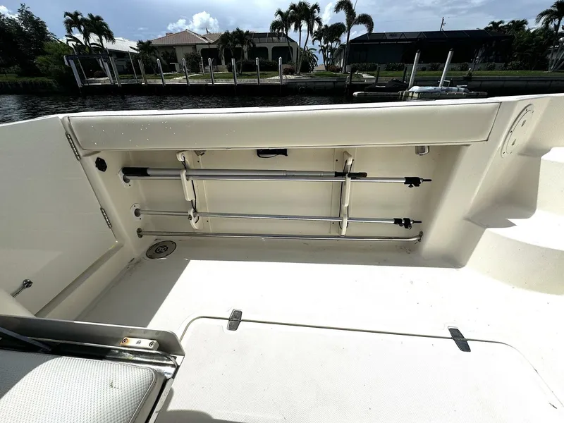 Slide: The Image of 2010 Pursuit OS 345 Offshore boat interior with rod holders and storage compartments. - 23