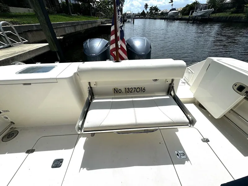 Slide: The Image of 2010 Pursuit OS 345 Offshore boat with twin engines and seating area. - 24