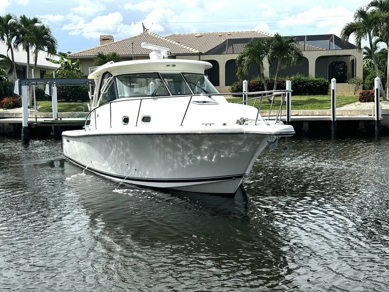 Slide: The Image of 2010 Pursuit OS 345 Offshore boat docked in a residential canal. - 27