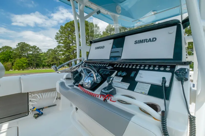 Slide: The Image of 2019 Fountain 34CC boat dashboard with Simrad electronics and steering wheel. - 8