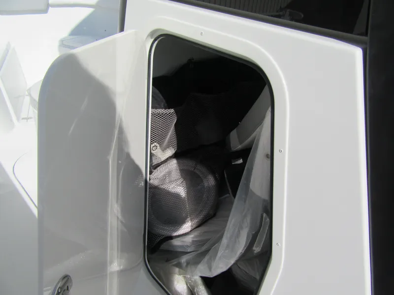Slide: The Image of Storage compartment on a 2025 Parker 2600 Center Console boat, partially open. - 15