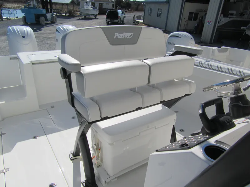 Slide: The Image of 2025 Parker 2600 Center Console boat interior with white seating and helm station. - 8
