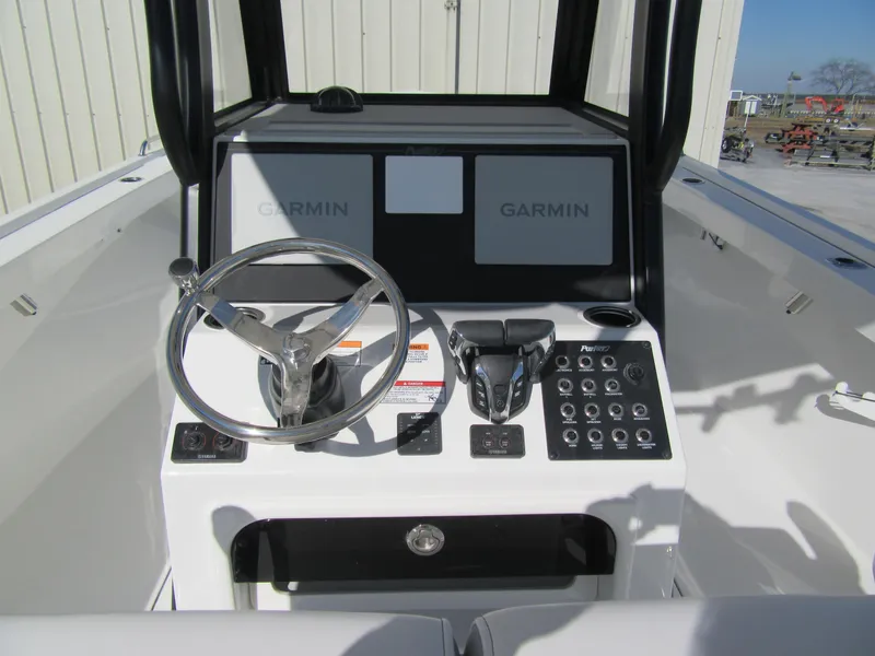 Slide: The Image of 2025 Parker 2600 Center Console boat dashboard with Garmin displays and steering wheel. - 9