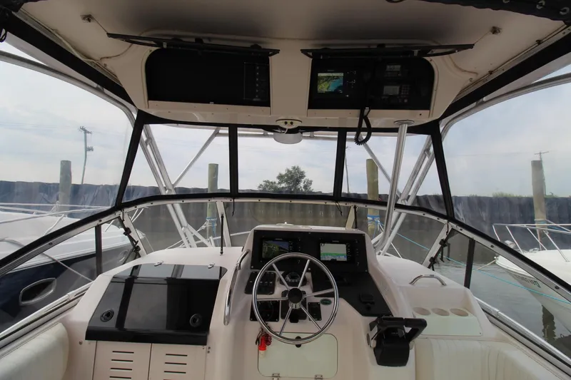 Slide: The Image of 2002 Grady-White Express 265 boat helm with navigation equipment and steering wheel. - 10