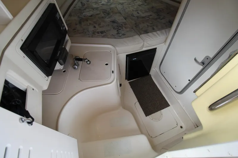Slide: The Image of Interior cabin of 2002 Grady-White Express 265 boat with kitchenette and sleeping area. - 14