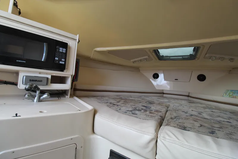 Slide: The Image of Interior cabin of a 2002 Grady-White Express 265 boat with microwave and bed. - 16