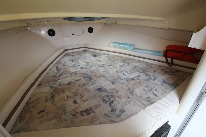 Slide: The Image of 2002 Grady-White Express 265 cabin interior with cushioned sleeping area. - 17