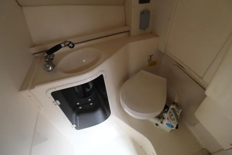 Slide: The Image of 2002 Grady-White Express 265 boat bathroom with sink and toilet. - 22