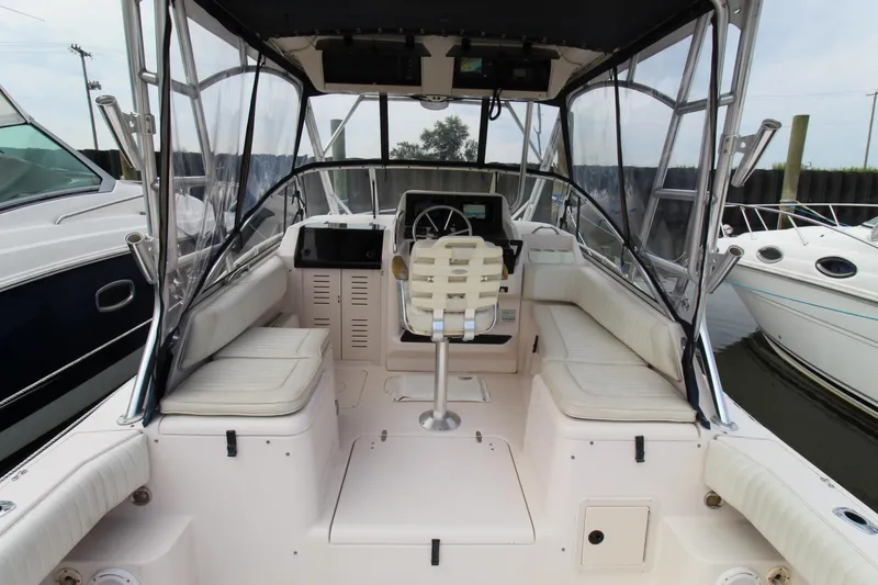 Slide: The Image of Interior of 2002 Grady-White Express 265 boat with seating and helm station. - 23