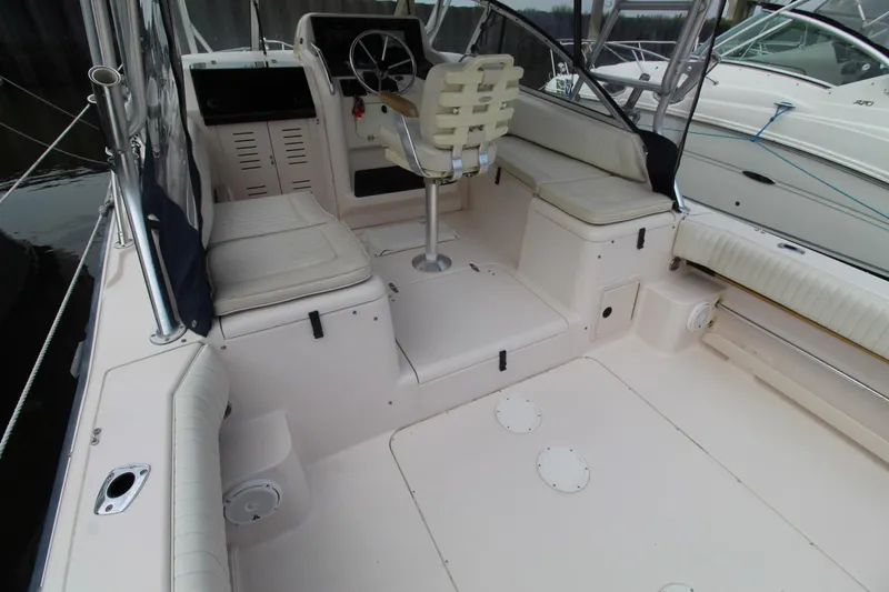 Slide: The Image of 2002 Grady-White Express 265 boat interior with seating and steering console. - 24