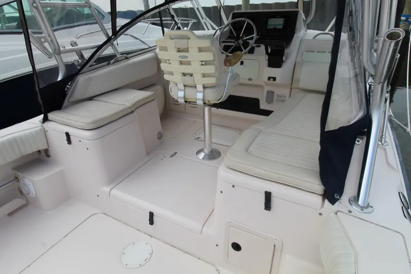 Slide: The Image of 2002 Grady-White Express 265 boat interior with helm, seating, and storage compartments. - 25