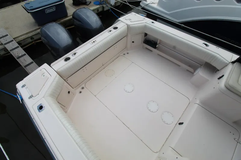 Slide: The Image of 2002 Grady-White Express 265 boat deck with twin outboard motors at dock. - 27