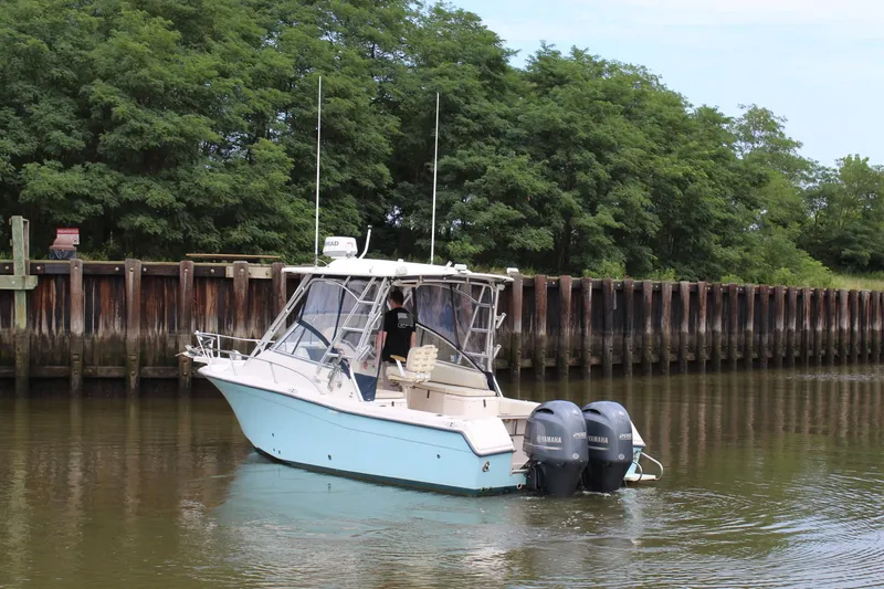 Slide: The Image of 2002 Grady-White Express 265 boat with twin Yamaha engines on calm water. - 33