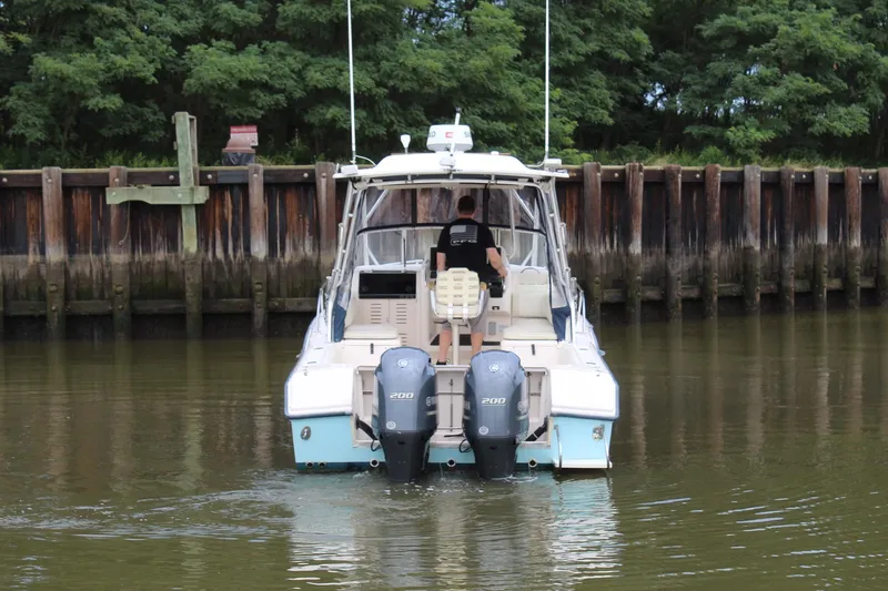 Slide: The Image of 2002 Grady-White Express 265 boat with twin Yamaha 200 engines in a calm waterway. - 34