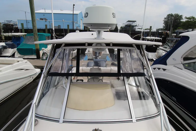 Slide: The Image of 2002 Grady-White Express 265 boat docked at a marina. - 5