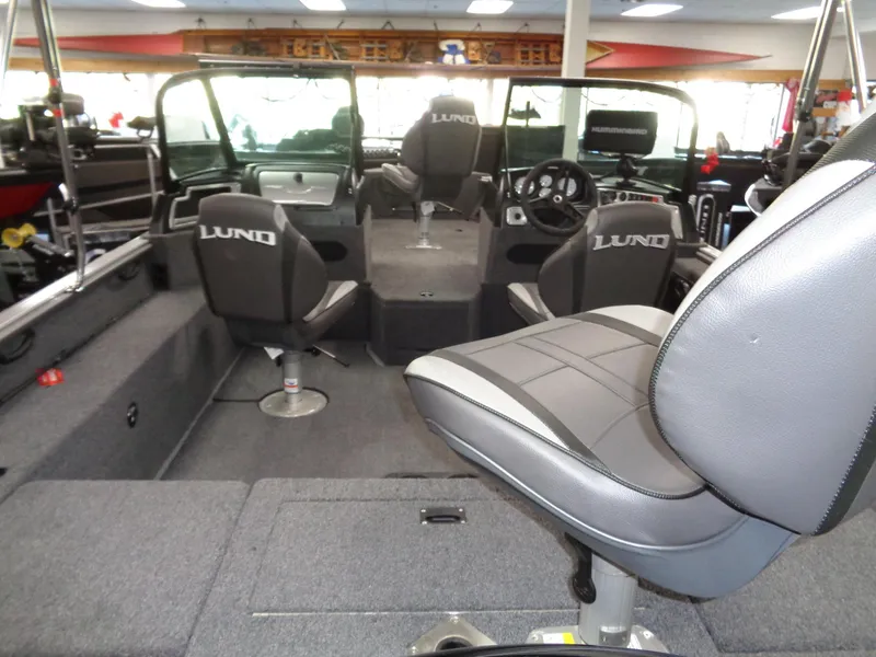 Slide: The Image of 2024 Lund 1775 Impact XS boat interior with seating and console. - 11
