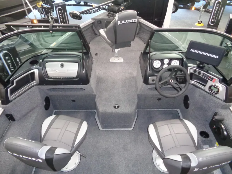 Slide: The Image of 2024 Lund 1775 Impact XS boat interior with seating and control panel. - 12
