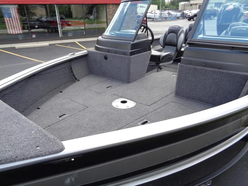 Slide: The Image of 2024 Lund 1775 Impact XS boat interior with spacious deck and seating. - 18