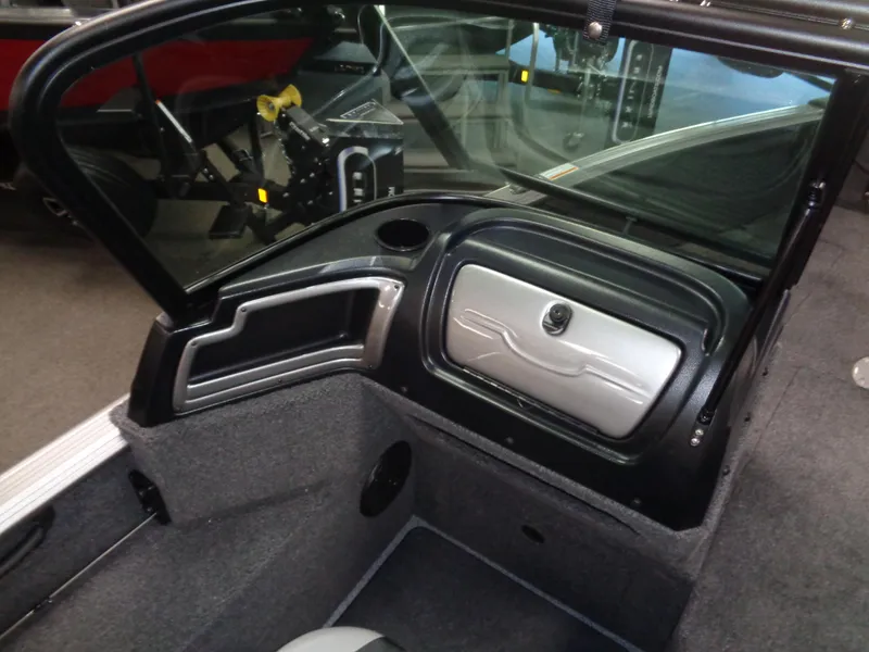 Slide: The Image of 2024 Lund 1775 Impact XS boat interior dashboard and storage compartment. - 21