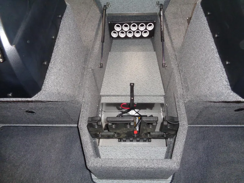 Slide: The Image of 2024 Lund 1775 Impact XS boat interior storage compartment with rod holders. - 30