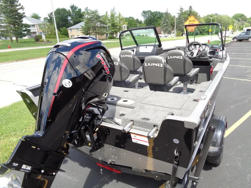 Slide: The Image of 2024 Lund 1775 Impact XS boat with outboard motor and seating. - 8