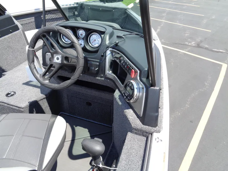 Slide: The Image of 2024 Lund 1775 Impact XS boat dashboard and steering wheel. - 15
