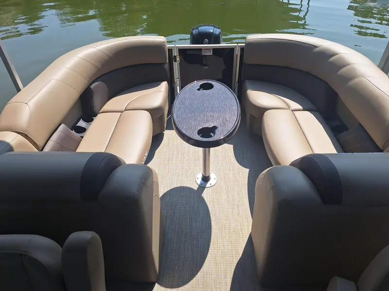 Slide: The Image of 2025 Sylvan Mirage 822 LZ pontoon boat interior with plush seating and central table. - 4