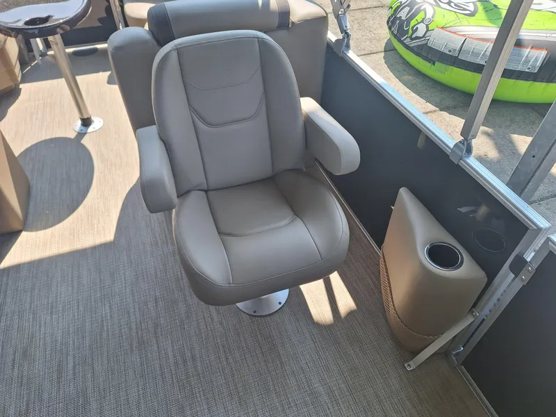 Slide: The Image of Luxurious seating on 2025 Sylvan Mirage 822 LZ pontoon boat, featuring comfortable armchair and cup holder. - 9