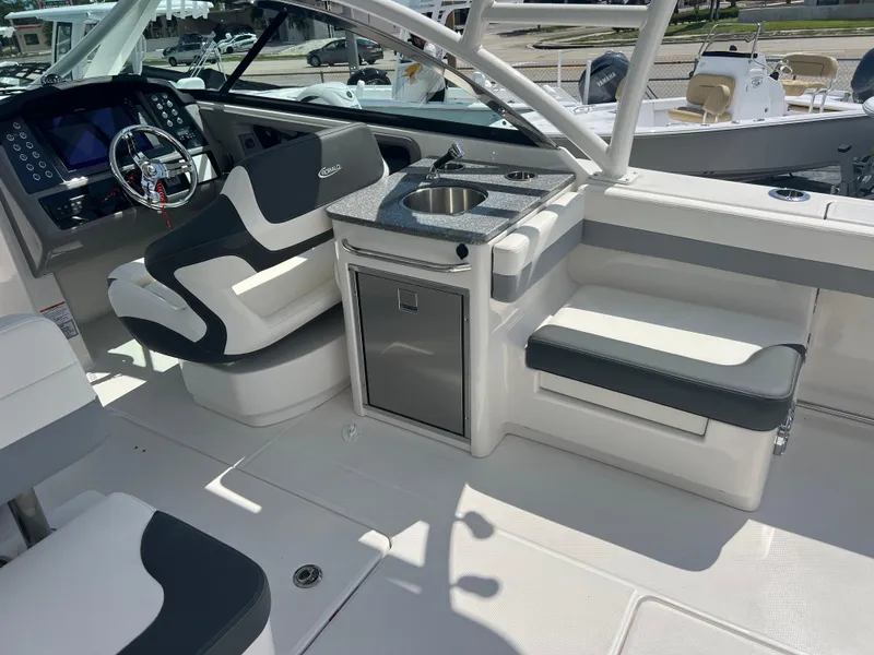Slide: The Image of 2024 Robalo R317 Dual Console boat interior with seating and kitchenette. - 11