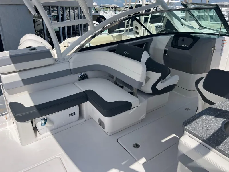 Slide: The Image of 2024 Robalo R317 Dual Console boat interior with white and gray seating. - 12