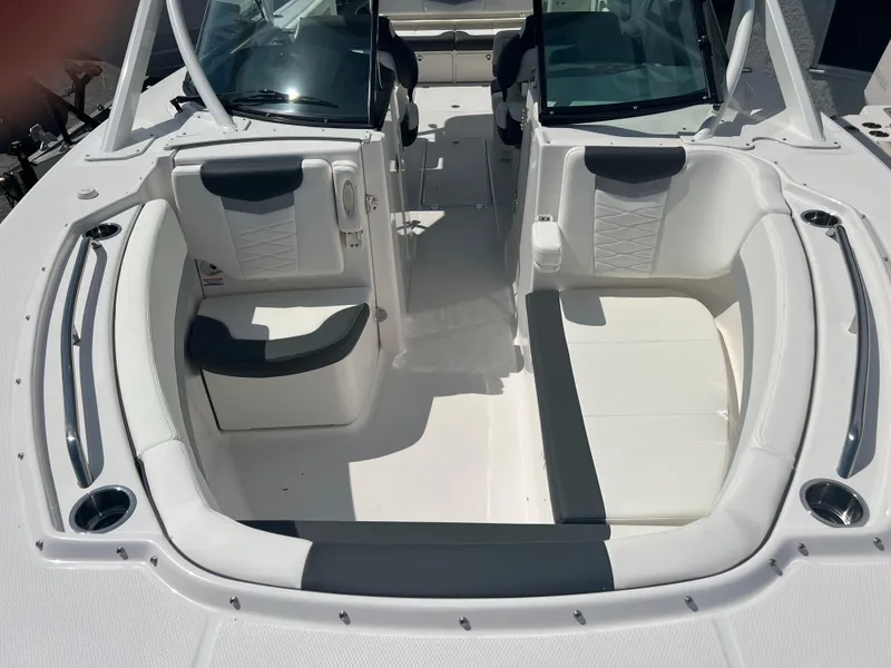 Slide: The Image of 2024 Robalo R317 Dual Console boat interior with white seating and dual consoles. - 17