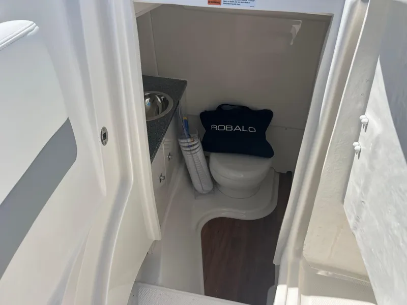Slide: The Image of 2024 Robalo R317 Dual Console boat interior bathroom with sink and toilet. - 19