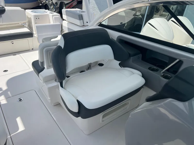 Slide: The Image of 2024 Robalo R317 Dual Console boat interior with white and black seating. - 22