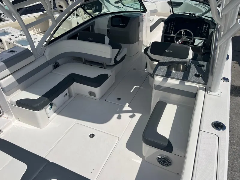 Slide: The Image of 2024 Robalo R317 Dual Console boat interior with seating and helm. - 9