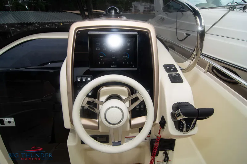 Slide: The Image of 2024 Invictus TT280S boat helm with steering wheel and control panel. - 14