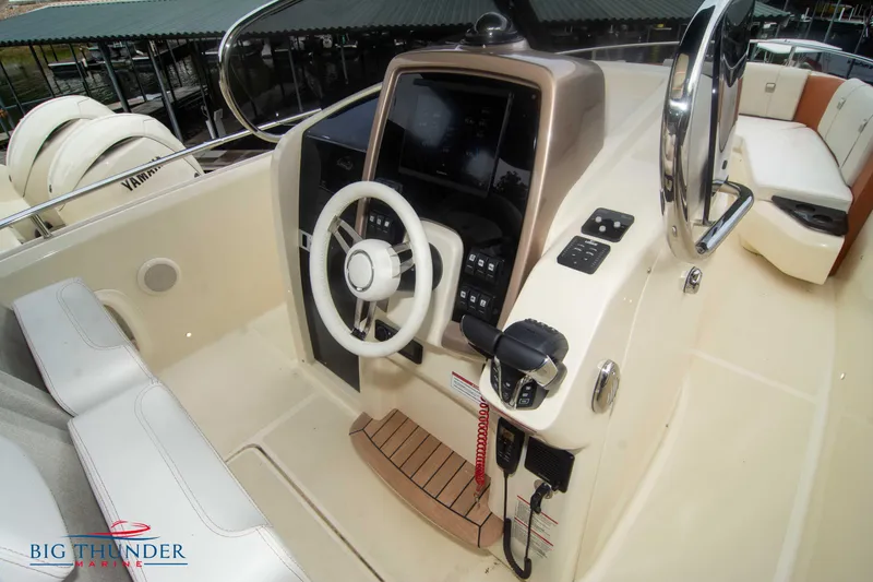 Slide: The Image of 2024 Invictus TT280S boat cockpit with steering wheel and control panel. - 15