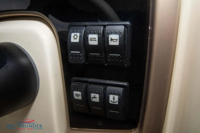 Slide: The Image of Control panel of 2024 Invictus TT280S boat with various switches. - 19