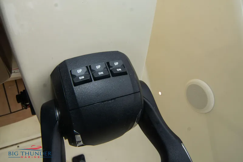 Slide: The Image of Close-up of Invictus TT280S 2024 boat throttle control with trim buttons. - 25