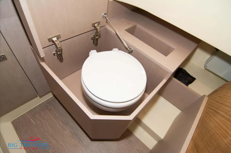 Slide: The Image of 2024 Invictus TT280S boat bathroom with modern fixtures and wooden cabinetry. - 34