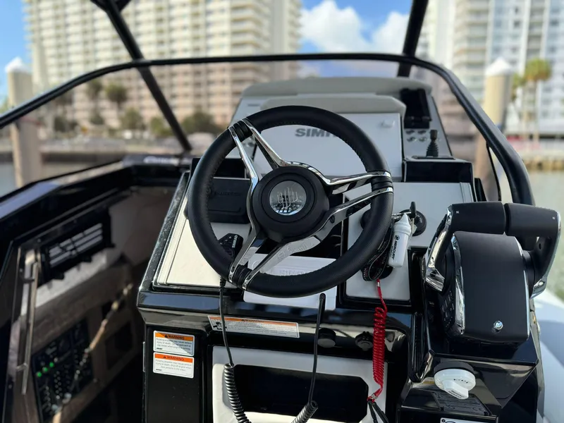 Slide: The Image of 2025 Ranieri CAYMAN 38.0 EXECUTIVE boat helm with modern controls and cityscape background. - 16
