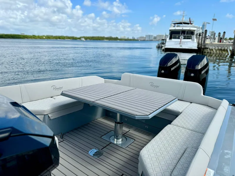 Slide: The Image of 2025 Ranieri CAYMAN 38.0 EXECUTIVE boat with seating area and table on calm water. - 39