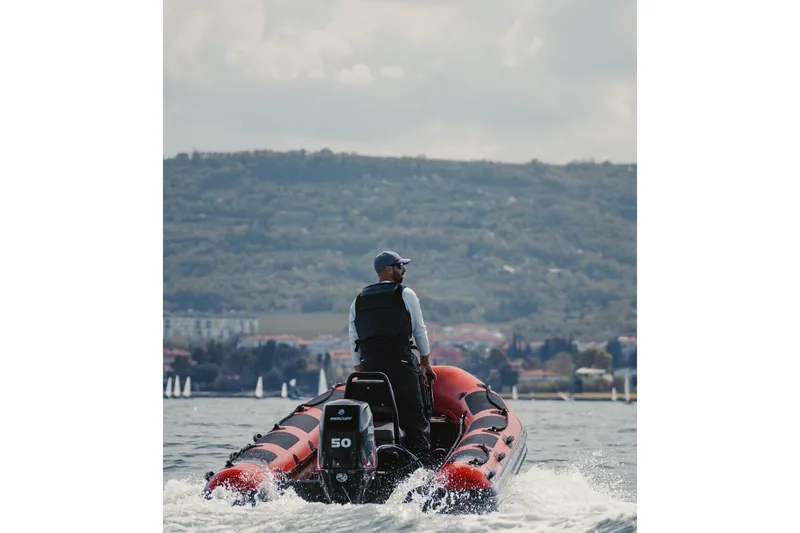 Slide: The Image of Man driving 2026 Highfield Patrol 460 boat on the sea. - 11