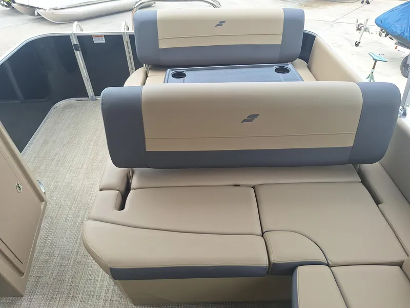 Slide: The Image of 2024 Starcraft EX 22 Weekender boat interior with beige and gray seating. - 10