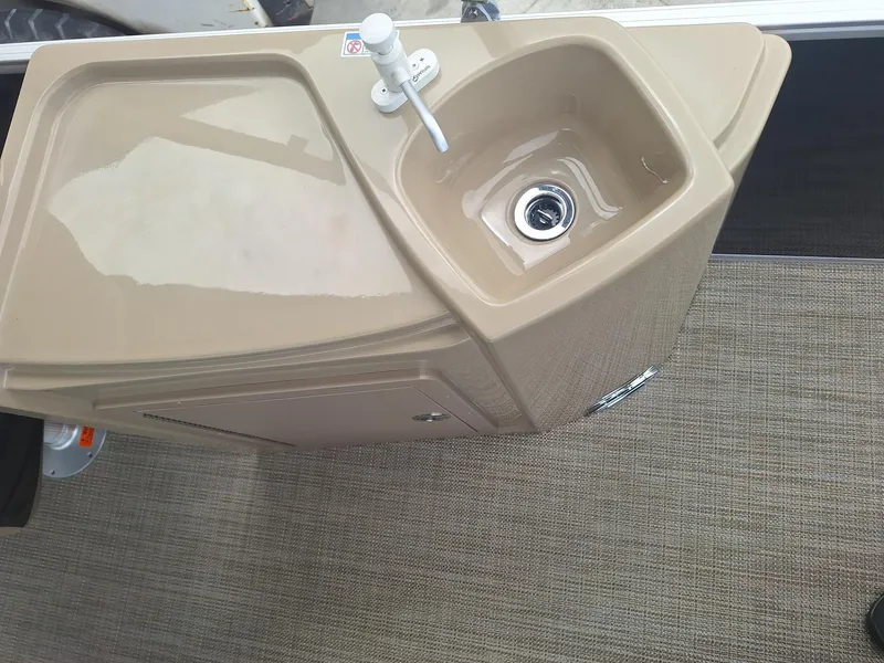 Slide: The Image of 2024 Starcraft EX 22 Weekender boat sink with beige countertop. - 15