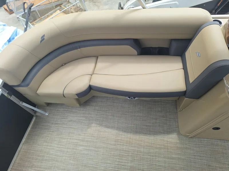 Slide: The Image of 2024 Starcraft EX 22 Weekender boat interior with beige and gray seating. - 17